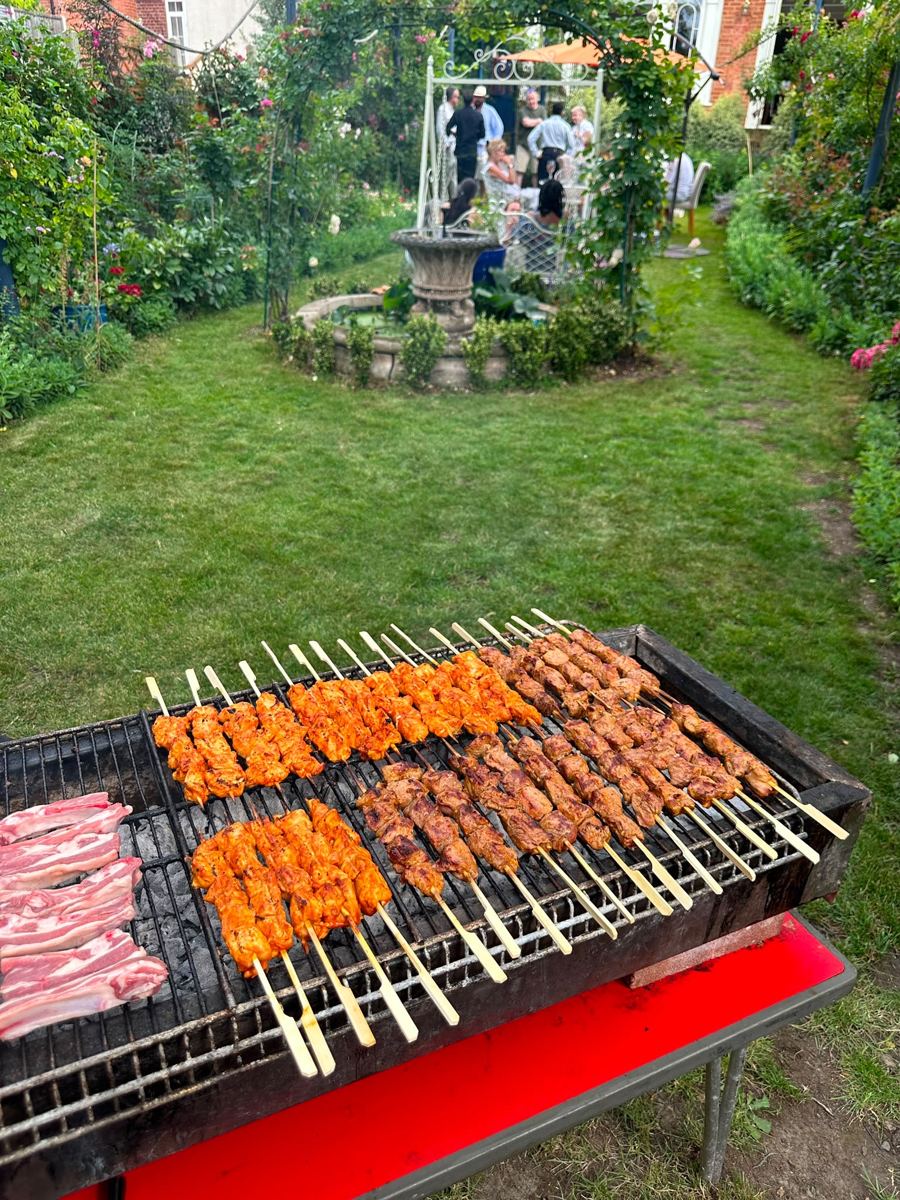 Skewers on a charcoal grill at a garden party